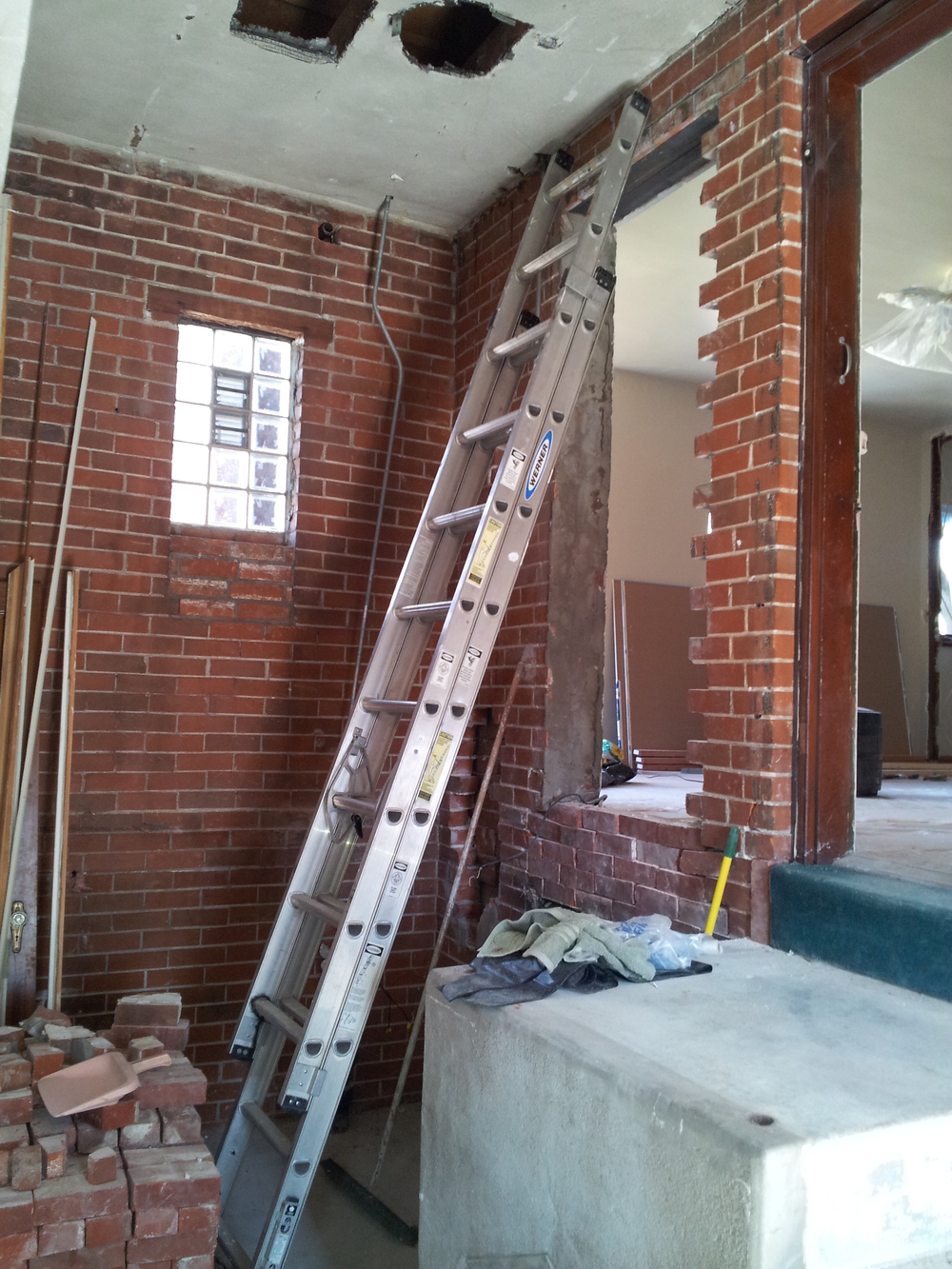 Existing entry door being relocated and filled in brick exterior